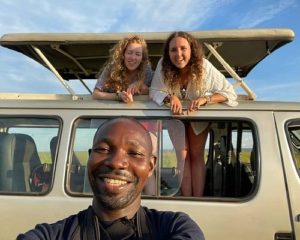 Tour guide with clients in Uganda